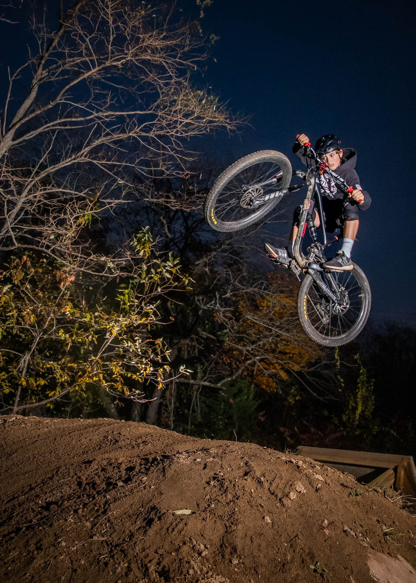 Dirt jumper catching air at night
