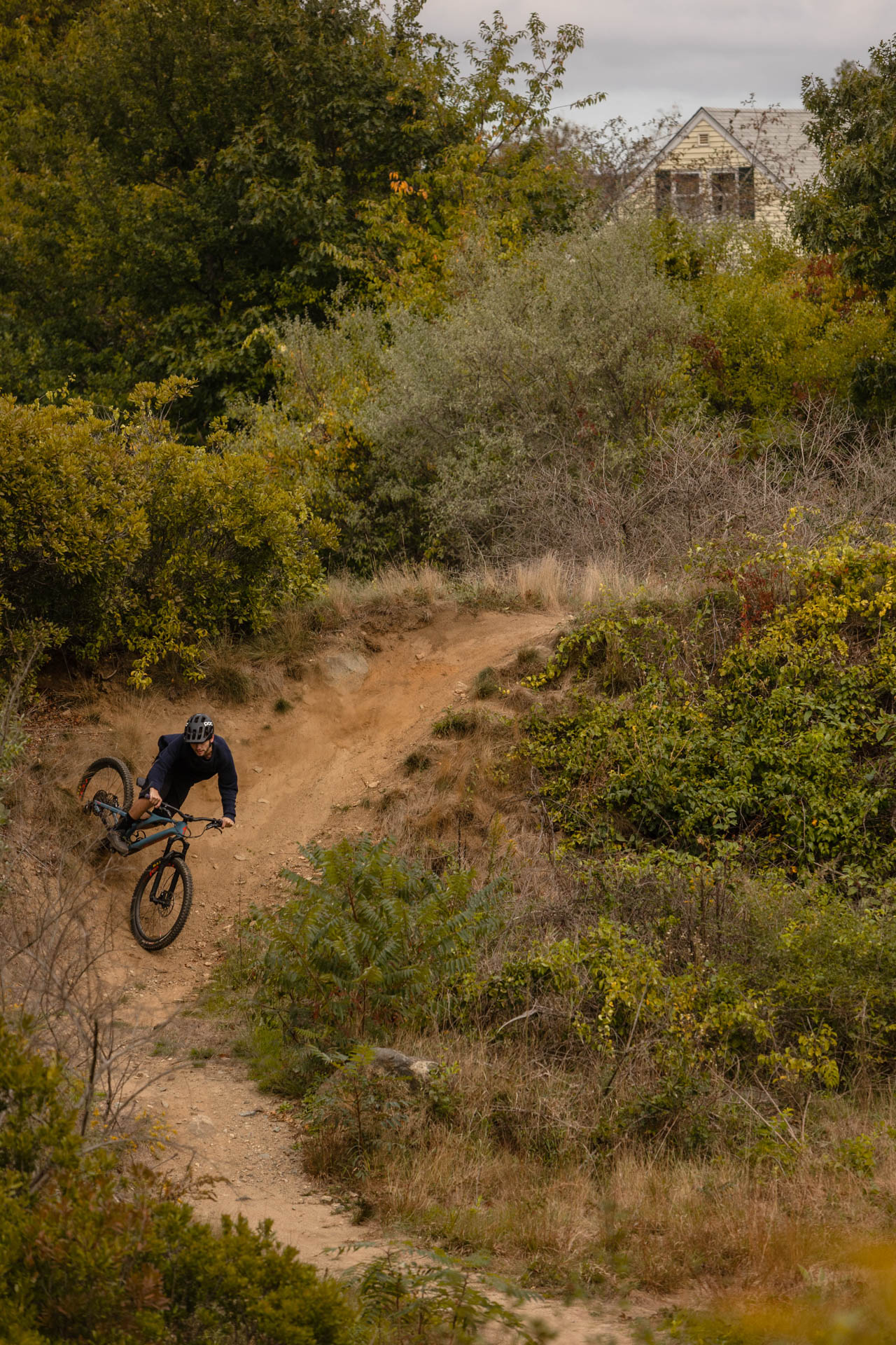 Biker airborne over a granite ledge