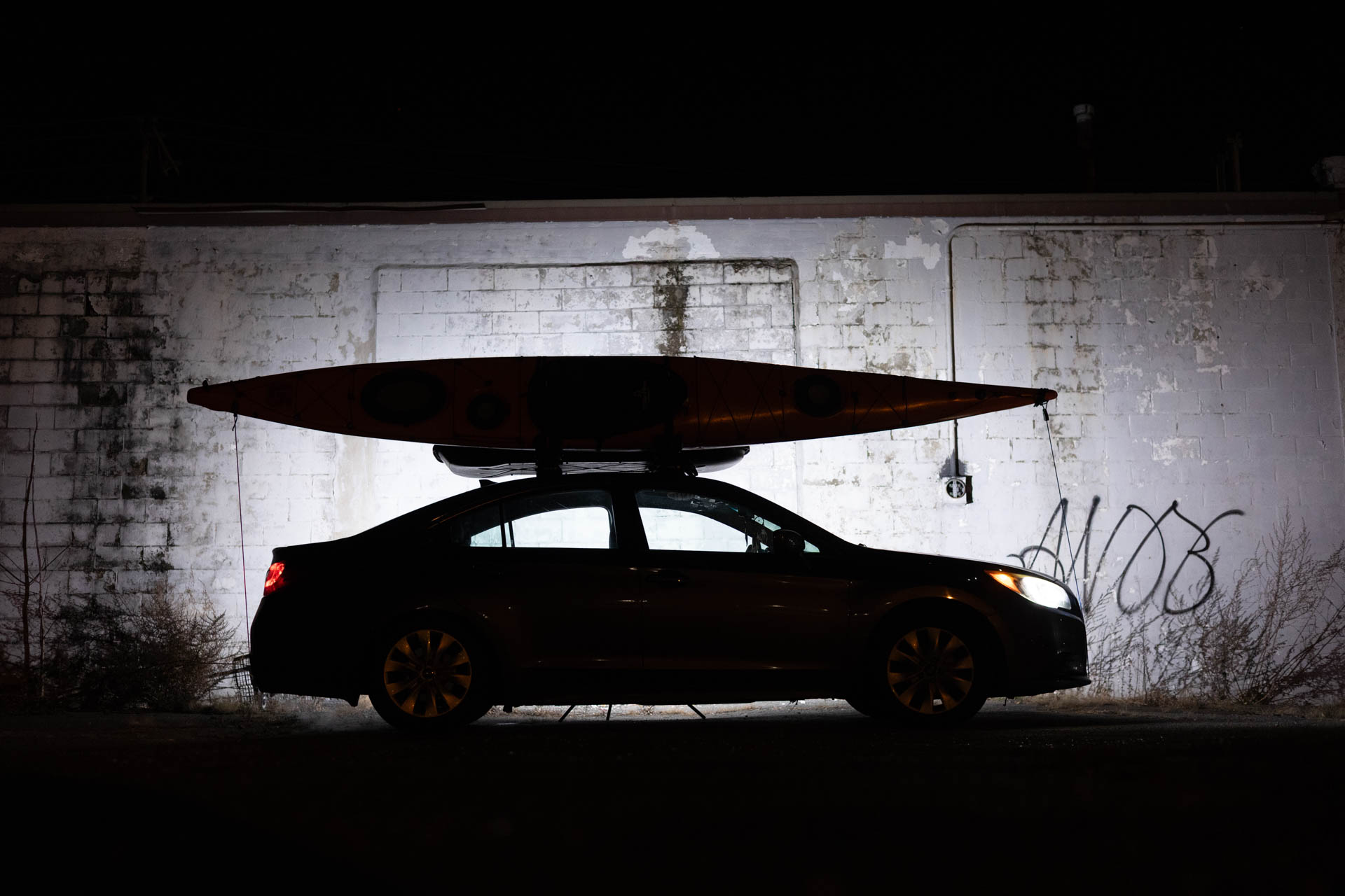Kayak loaded on the car at night