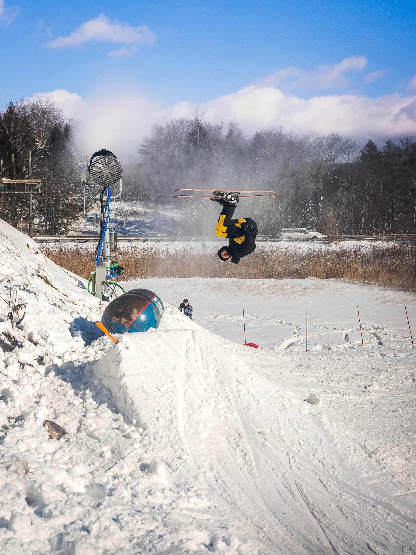 Skier inverted mid-backflip