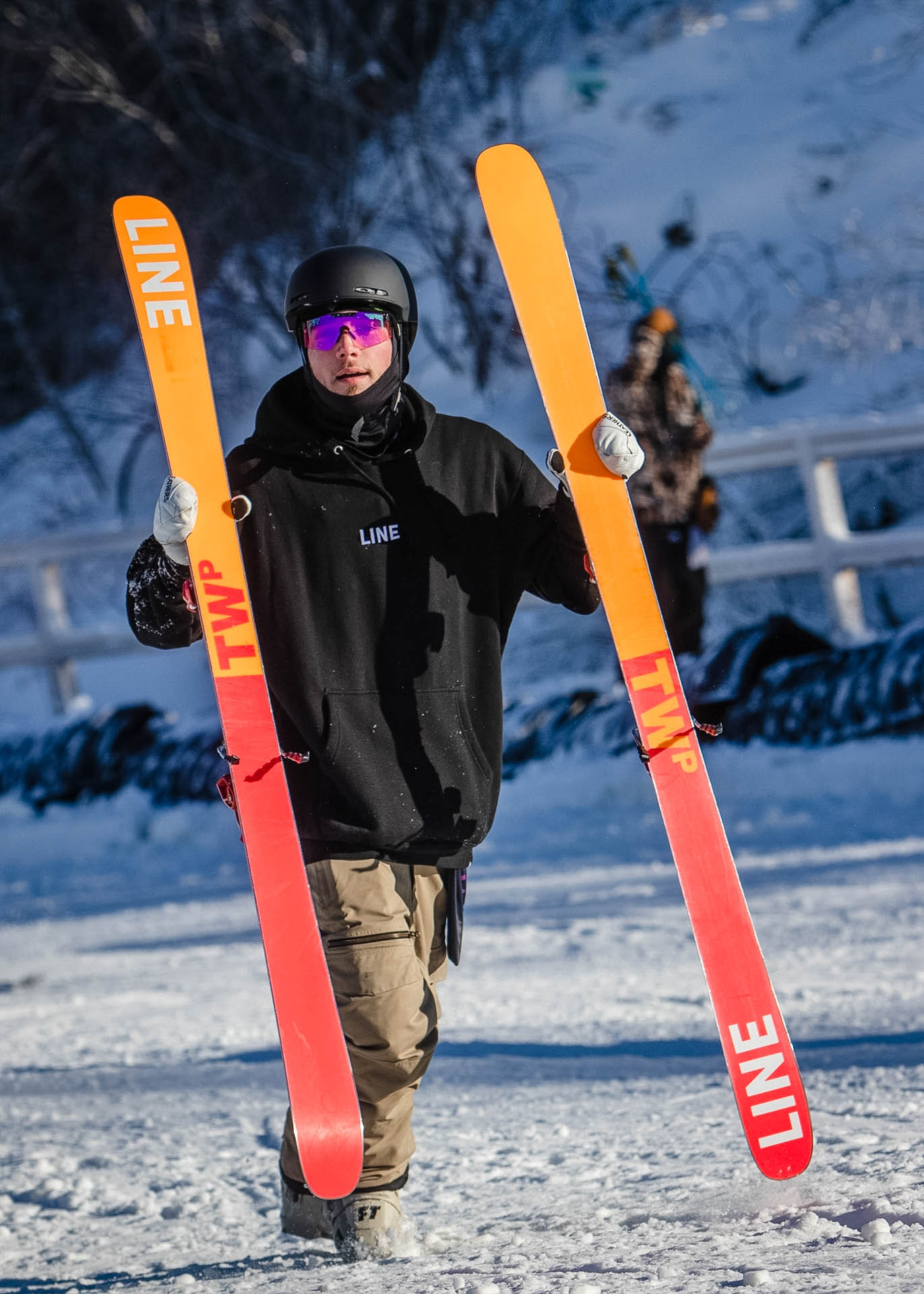 Skier hiking back up with skis in hand